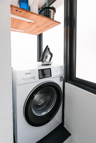 a washer and dryer in a tiny house at Rose House By Atlantic Holiday in Machico