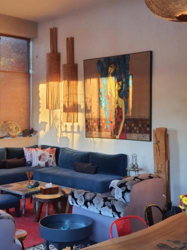 a living room with a blue couch and tables at Casa Taos in Marrakech