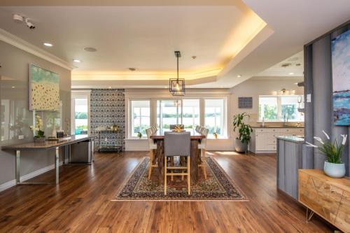 a kitchen and dining room with a table and chairs at OCEAN BAY VIEW Luxury Guesthouse in Musquodoboit Harbour