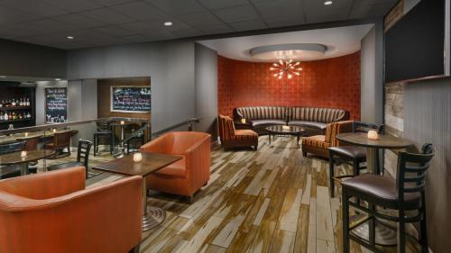 a restaurant with tables and chairs and a bar at Crowne Plaza Phoenix Airport - PHX by IHG in Phoenix