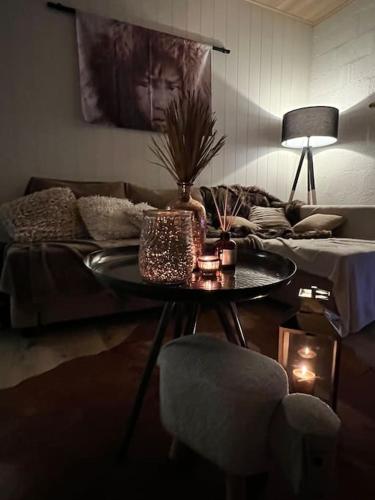 a living room with a table and a couch at Cabane La Folie Douce in Hotton