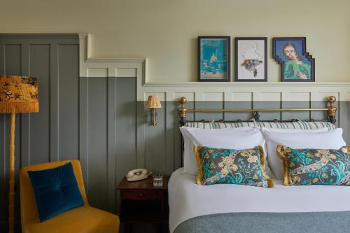 a hotel room with a bed and a chair at Hotel Indigo - Exeter by IHG in Exeter