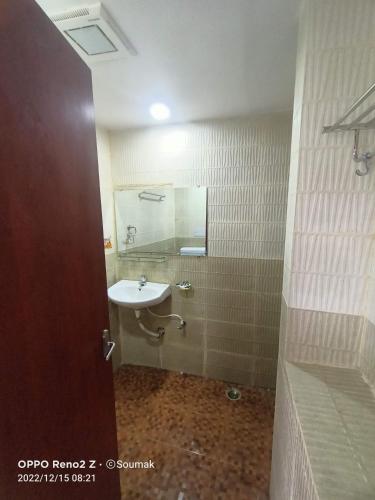 a bathroom with a sink and a mirror at Sunderban Tiger Residency in Gosāba