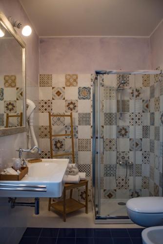 a bathroom with a sink and a shower at Ca' Virginia Country House Wellness in Montecalvo in Foglia