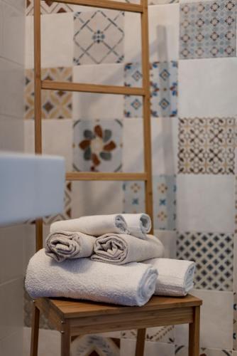 a pile of towels on a table with a lamp at Ca' Virginia Country House Wellness in Montecalvo in Foglia