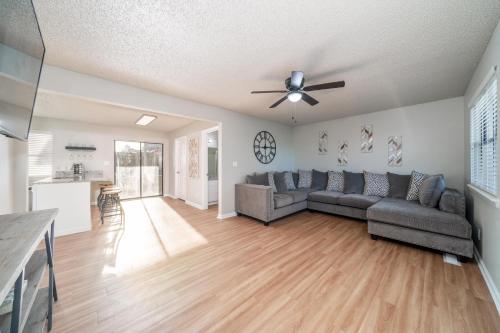 a living room with a couch and a ceiling fan at The Hamilton - Lakefront & Studio Suites, Hot Springs in Hot Springs