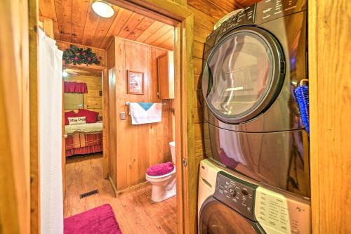 a tiny house with a microwave in a room at Cozy Tellico Plains Cabin with Large Mountain Creek! in Tellico Plains