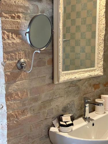 a bathroom with a mirror and a sink at Ca' Virginia Country House Wellness in Montecalvo in Foglia