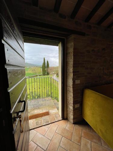 a room with a door to a balcony with a view at Ca' Virginia Country House Wellness in Montecalvo in Foglia