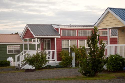 a row of houses with red and green at Narrows Too Camping Resort Loft Cottage 12 in Trenton