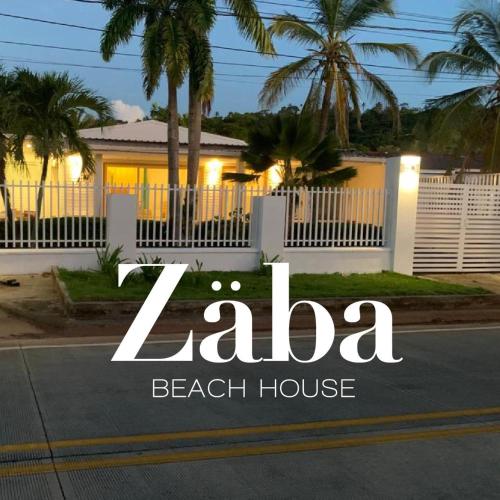 a sign that says la beach house in front of a house at Zaba Beach House in San Andrés
