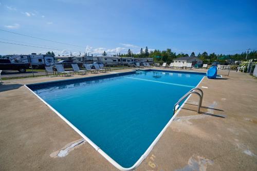 a large swimming pool in a parking lot at Narrows Too Camping Resort Loft Cottage 12 in Trenton