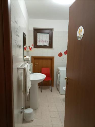 a bathroom with a white sink and a toilet at La villetta 2.0 in Rende
