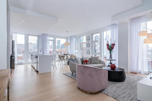 a living room with a couch and a table at Le Se7t Penthouses in Montréal