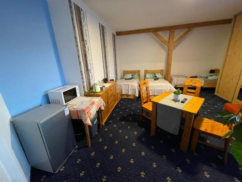 a room with two beds and a tv in it at Penzion SLUNCE in Česká Lípa