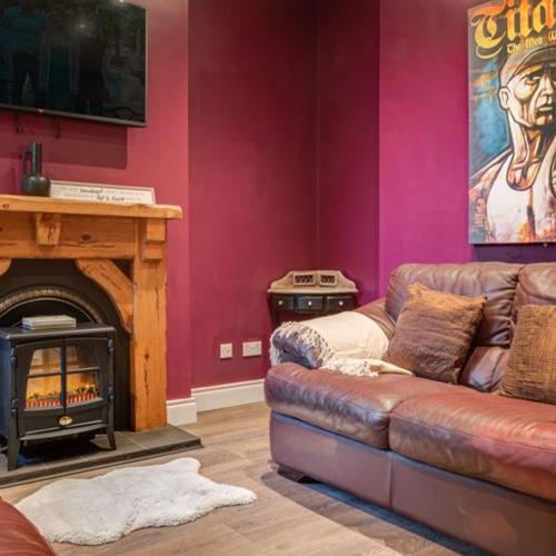 a living room with a couch and a fireplace at Somerset House in Bangor
