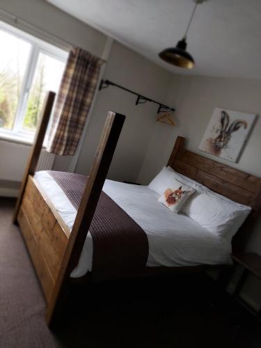 a bedroom with a bunk bed and a window at Grains Bar Hotel in Oldham
