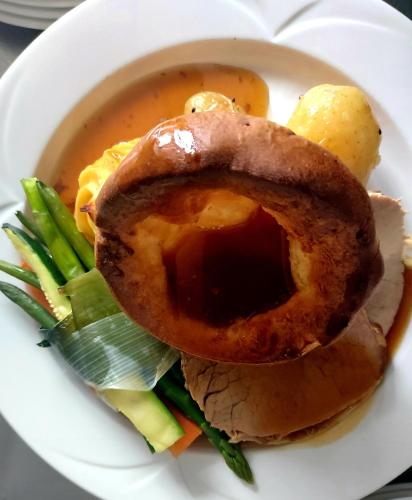 a plate with a sandwich and a bowl of soup at Grains Bar Hotel in Oldham