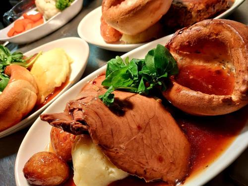 a plate of food with meat and pastries on a table at Grains Bar Hotel in Oldham
