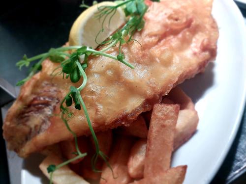 a plate of food with meat and french fries at Grains Bar Hotel in Oldham