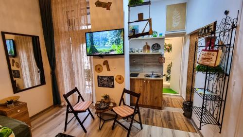 a living room with two chairs and a kitchen at My Lovely Palace in Sarajevo