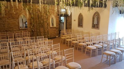 a room with rows of chairs in a building at Grains Bar Hotel in Oldham