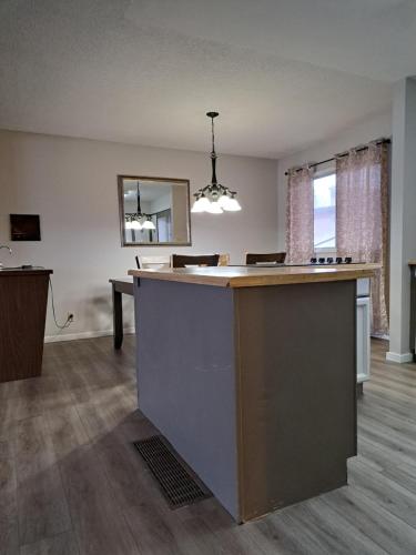 an empty room with a kitchen with a counter top at Richter Pass Beach Resort in Osoyoos