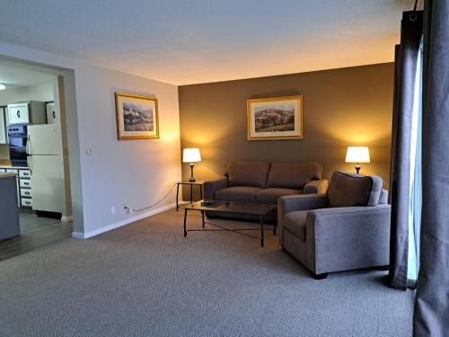 a living room with two chairs and a couch at Richter Pass Beach Resort in Osoyoos