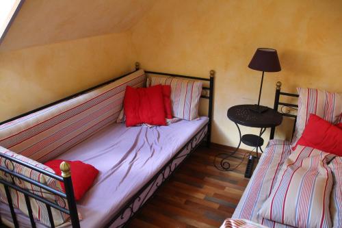 a bedroom with a bed with red pillows on it at Ferienwohnung Kunz in Burg