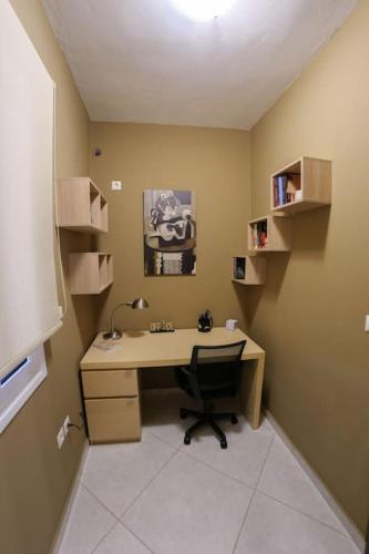 a office with a desk and a chair in a room at Garden house in Neapolis
