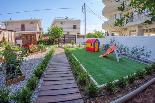 a garden with a playground with a play equipment at Garden house in Neapolis