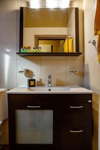 a bathroom with a sink and a mirror at Garden house in Neapolis