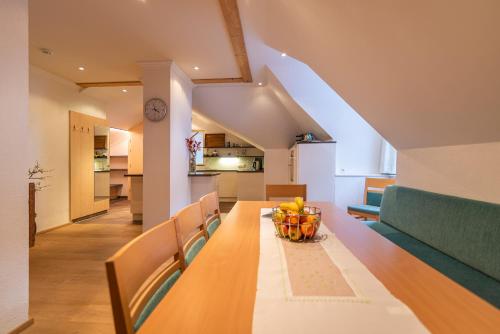 a dining room and kitchen with a table and chairs at Hotel Garni Martina in Ischgl