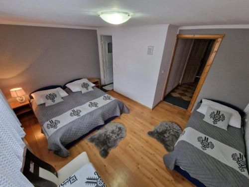 a bedroom with two beds and a hallway at Pokoje Gościnne Zych in Szczyrk