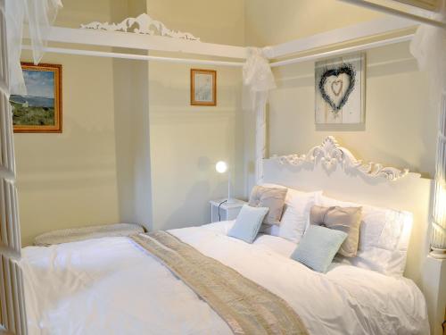 a white bedroom with a large white bed with pillows at Ganny House- Lvl in Eskdale