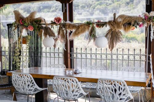 a table and chairs in a room with a window at Mistral Boutique Hotel in Meganisi