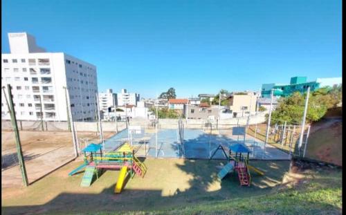 a park with a playground with slides and slidesktop at Apartamento bem localizado in São José