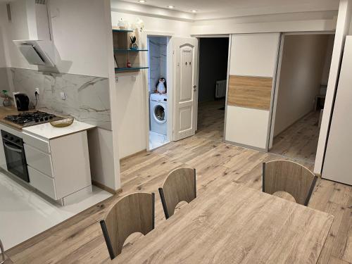 eine Küche und ein Wohnzimmer mit einem Tisch und Stühlen in der Unterkunft Apartament Centrum Okulickiego ! in Stalowa Wola