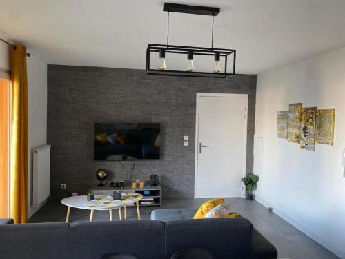 salon z kanapą i stołem w obiekcie La Petite Escapade w mieście Seynod