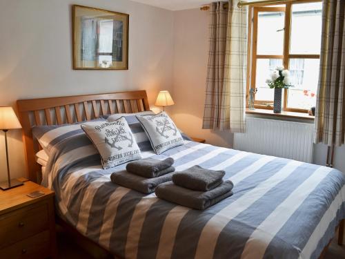 a bedroom with a bed with towels on it at Stoker Loft in West Mersea