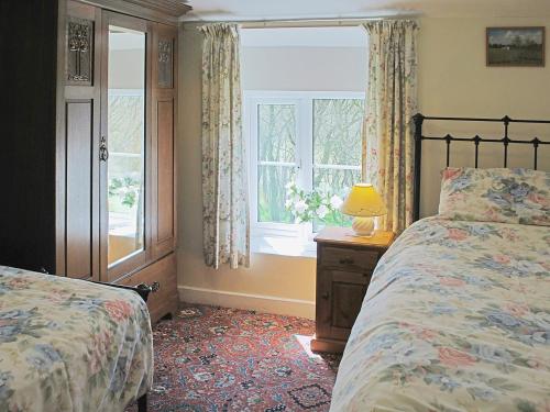 a bedroom with two beds and a window at Ryecroft in Bradwell