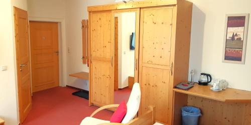 a room with a wooden cabinet and a desk at Villa Helvetia in Bad Elster