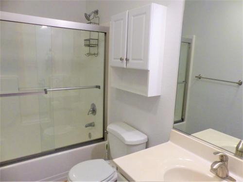 a bathroom with a shower and a toilet and a sink at KH5007- Fore Sea Suns in Kitty Hawk