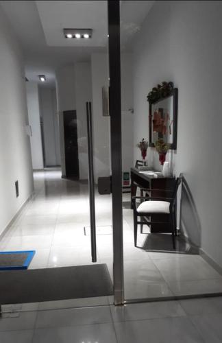 a room with a table and a chair and a mirror at Gaudium in Paraná
