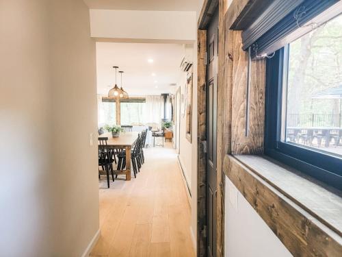 a hallway with a dining room and a window at Pinewood Lodge - Catskills, Windham Mountain, Hunter Mountain in Catskill