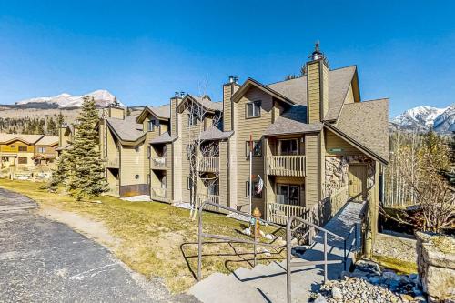 a large house with mountains in the background at Purgatory Perch in Durango Mountain Resort