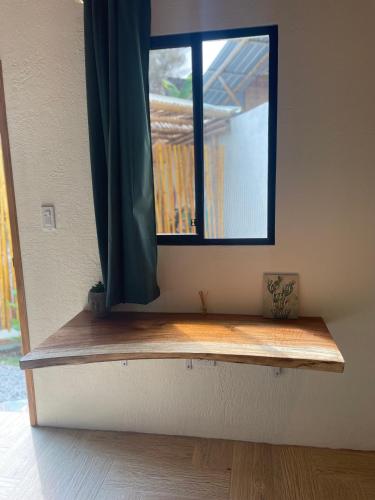 a window in a room with a wooden counter at Casa del Sol in Montañita
