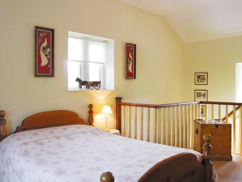 a bedroom with a bed and a window at Halton Gill Cottage in Deepdale