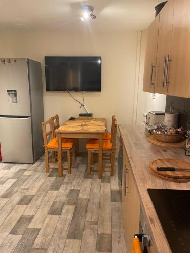 a kitchen with a table with chairs and a refrigerator at 7 Wellington place in Chester