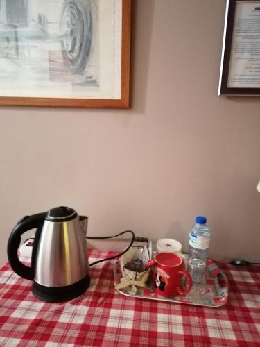 a tea kettle on a platter on a table at Chambres d'hôtes chez Loulou et Caramel in Magstatt-le-Bas